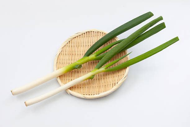 istock green onion isolated on white background 2253960139