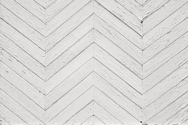 istock White chevron wooden wall with cracked paint texture. 2253960316