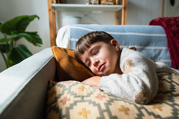 istock Young boy sleeping on couch during day nap 2253964995