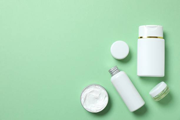 istock Natural cosmetic products on green background, top view 2253966740
