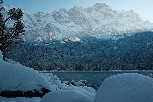 Snowcovered Mountains and Gondula Zugspitze Germany seen from Eibsee