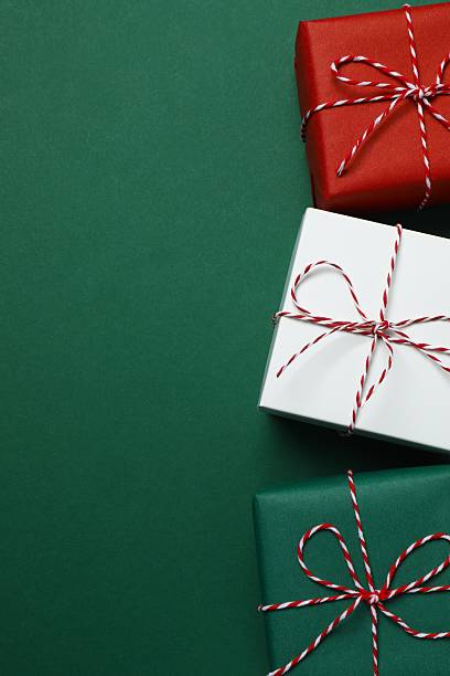 istock Beautiful Christmas gift boxes on green background 2253967088