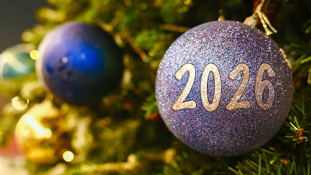 istock 2026 New Year Blue and silver Christmas baubles on evergreen tree with soft bokeh lights 2253967286
