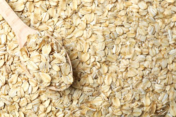 istock Composition with oatmeal flakes background. Cooking breakfast 2253968295