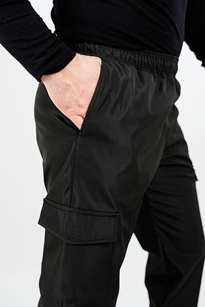istock Discover our stylish black cargo pants that feature an elastic waistband, designed for a comfortable fit while providing practical utility pockets for added functionality and convenience 2253968815