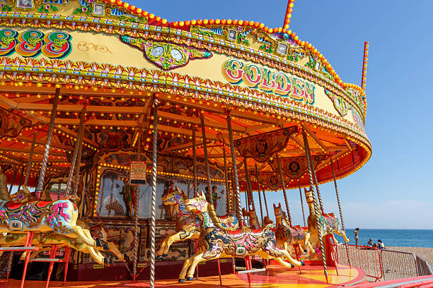 Brighton and Hove, UK - 20th June 2025A vintage-style carousel with painted wooden horses located on the seafront in Brighton, England.