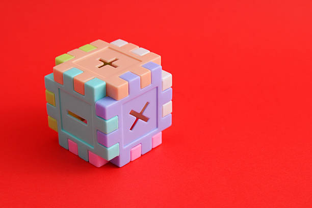Puzzle pieces form a cube with addition, subtraction, and multiplication signs