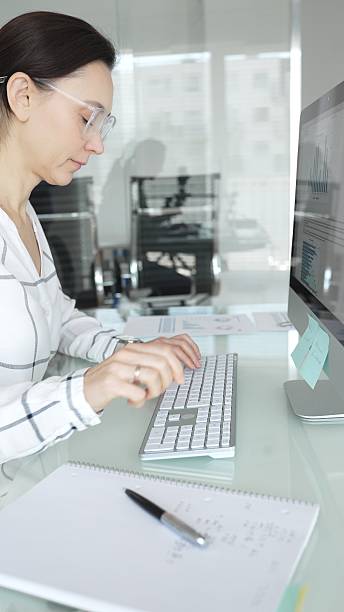 istock Woman analyst working on computer, analyzing business data with charts and graphs, marketing report on screen. Businesspeople concept 2253975096