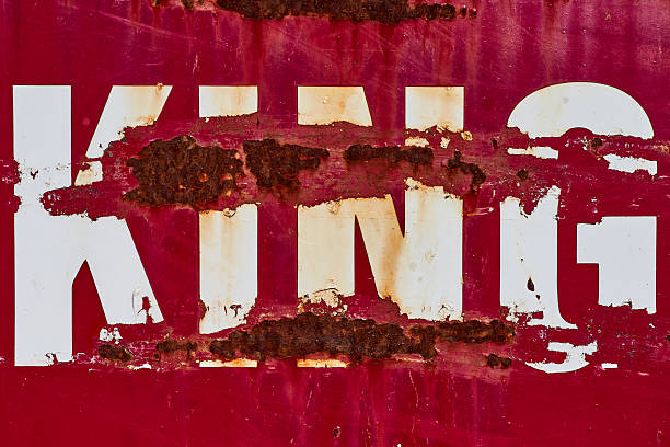 Rusted KING Text on Corroded Red Metal Surface, Close-Up