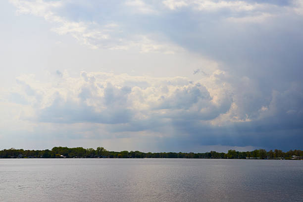 Dramatic clouds and serene lake at Winona Lake, Indiana, hint at an approaching storm.