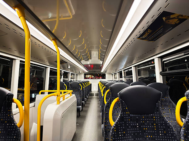 Manchester, UK - December 05, 2025: Empty bus cabin in Manchester captures urban transit design, bright lights, comfortable seating.