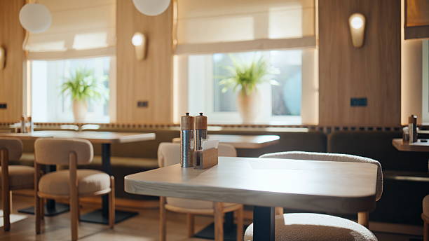 istock Cozy modern restaurant tables under warm light original lamps. Cafe interior 2253976154