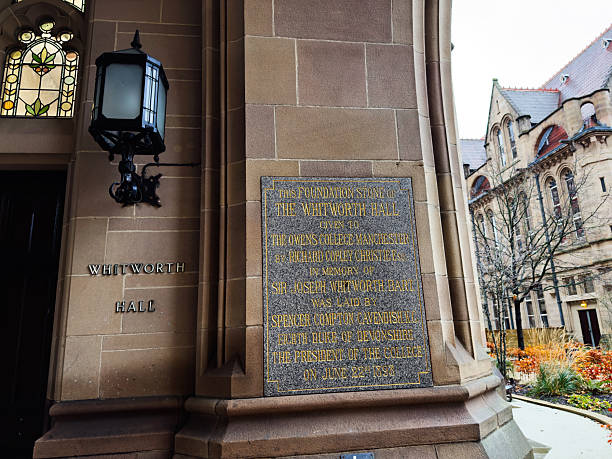 Manchester, UK - December 06, 2025: Historic Whitworth Hall features a foundation stone plaque and ornate architecture in Manchester, UK.