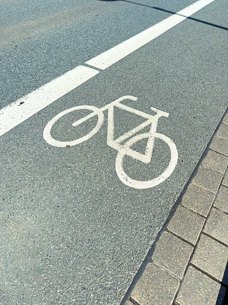 istock The distinctive White Bicycle Lane Marking on the Asphalt Road is an essential feature that actively promotes Cycling Safety and enhances Urban Mobility for cyclists commuting through the area 2253981051