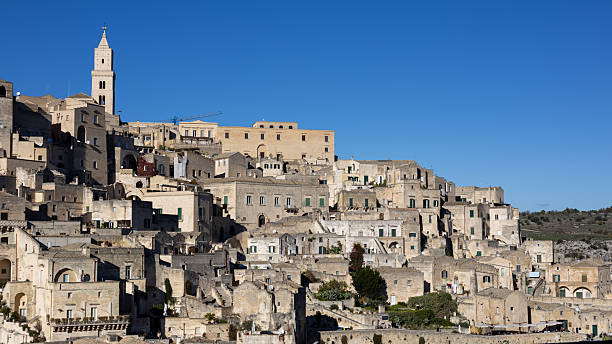 istock stunning panoramic view of the ancient sassi di matera under a clear blue sky, showing traditional stone houses and the historic bell tower in basilicata, italy. 2253982069