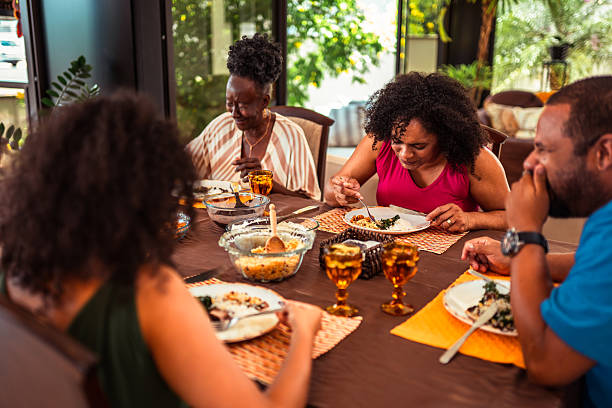 istock Multi-generational Black family enjoying a meal together at a dining table. 2253987945