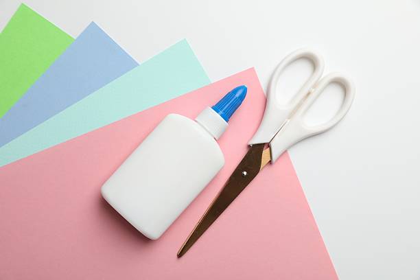 istock Glue, scissors and color paper on white background, flat lay 2253992159