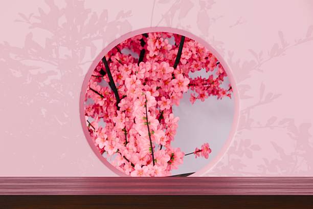 istock 3d wooden tabletop with round window and cherry blossom background. romantic spring luxury concept. clean studio scene with soft daylight for product branding display. 3d render. 2253993215