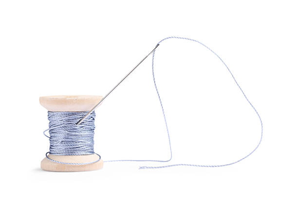 Spool of Blue Thread on Vintage Pink Beaded Fabric