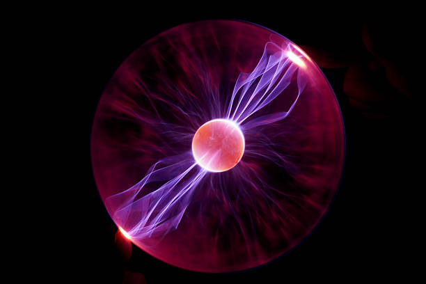 Plasma Ball with human hand causing plasma flow to jump to fingers creating unique patterns and textures of light.