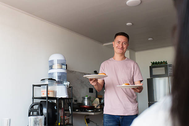 istock Happy man serving breakfast in home kitchen 2253995824