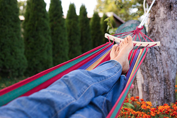 Senior woman resting in hammock outdoors, closeup