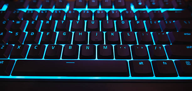 istock Backlit Gaming Keyboard with Cyan Blue LED Light Close-up 2253999695