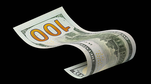 istock Curved hundred dollar banknote, isolated on black background 2254006289