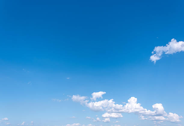 istock Panoramic view of clear blue sky and clouds, Blue sky background with tiny clouds. White fluffy clouds in the blue sky. Captivating stock photo featuring the mesmerizing beauty of the sky and clouds. 2254006644