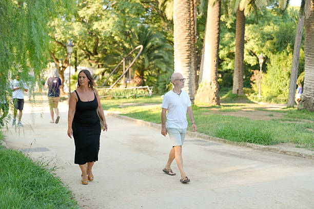 istock A man and a woman are walking down a path in a park 2254006857