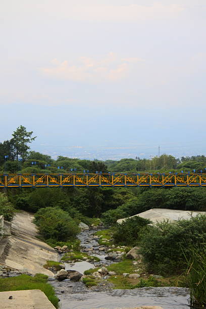 istock Yellow suspension bridge crossing over 2254007126