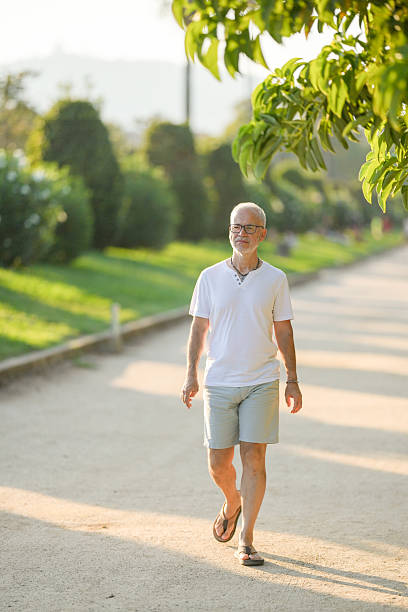 istock A man in a white shirt and shorts walks down a path 2254008461