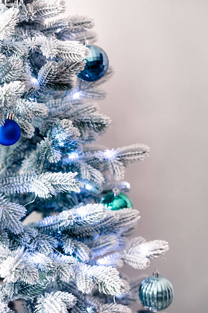 istock White christmas tree with blue decorations and bright illumination 2254011141