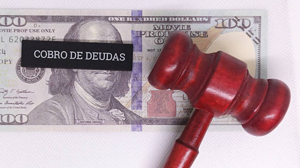 istock Judge gavel on $100 bill with debt collection label 2254011279