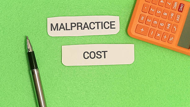 istock Malpractice cost concept with pen and calculator on green 2254011411