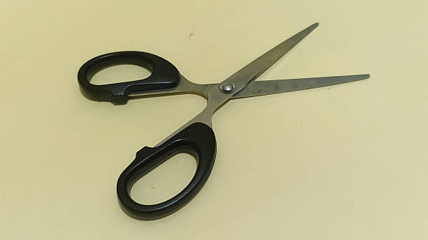 istock Scissors with black handles on pale background 2254011655