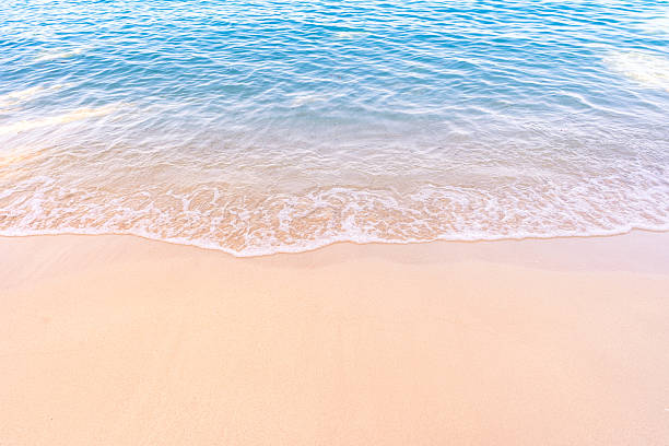 istock Soft blue ocean waves gently lapping onto a pristine tropical sandy beach 2254012601