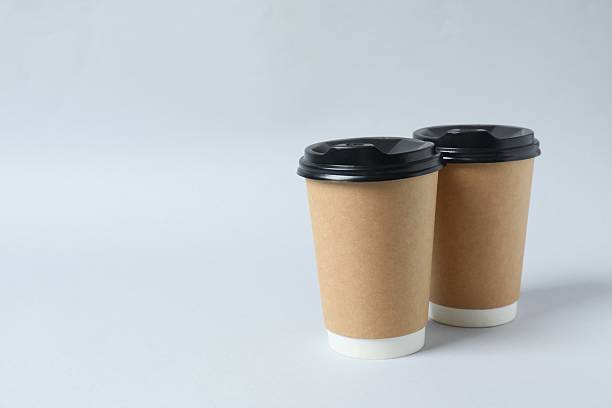 istock Paper cups with plastic lid on light background. Coffee to go 2254012628