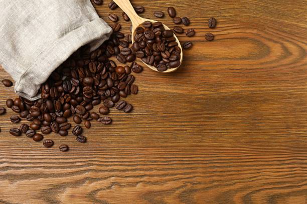 istock Fresh coffee beans on wooden background 2254012640