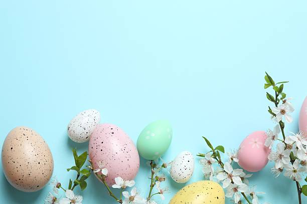 istock Happy Easter. Colorful eggs and white spring flowers on color background, space for text or advertising 2254014129