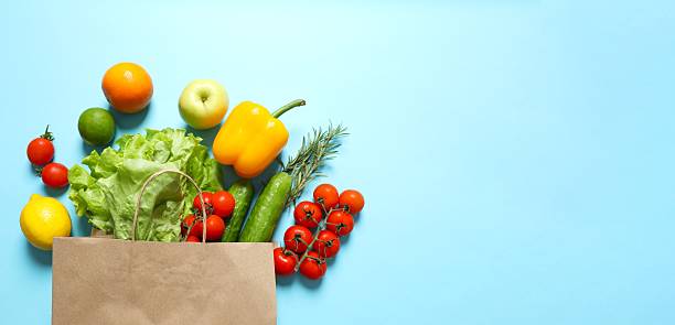 istock Paper bag, vegetables and fruits on a blue background, space for text 2254014319