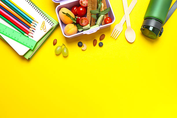 istock Packed lunch with sandwiches, fruits, nuts and vegetables in a divided container 2254015031