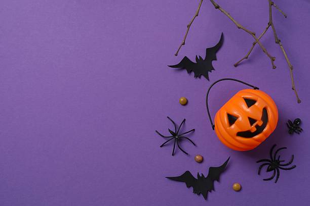 istock Halloween poscard with festive decorations on purple background . Top view, space for text 2254015108