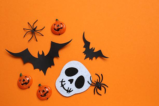 istock Halloween poscard with festive decorations on orange background . Top view, space for text 2254015112