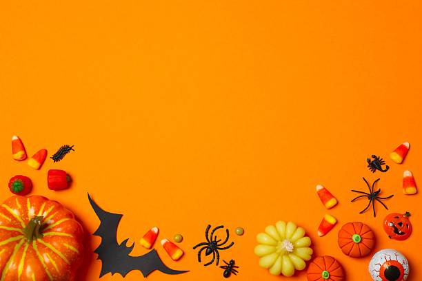 istock Halloween poscard with festive decorations on orange background . Top view, space for text 2254015217