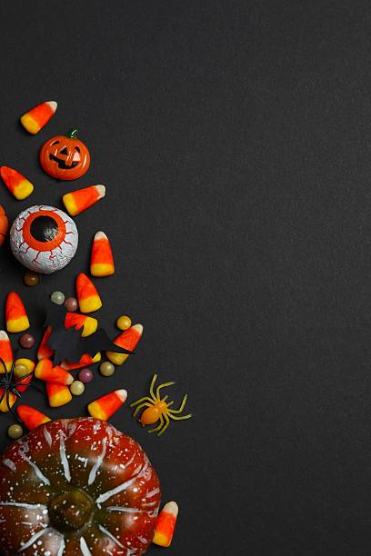 istock Halloween poscard with festive decorations on black background . Top view, space for text 2254015250