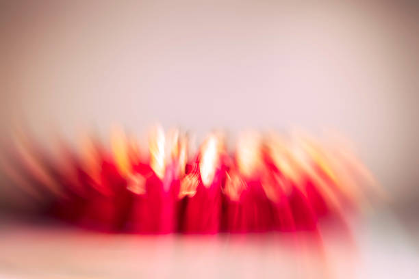 A dreamy, abstract motion-blur photograph of a ballet dancer performing in a warm, golden-lit underground space. The dynamic zoom effect creates a sense of energy, fluid movement and artistic expression. Ideal for themes of creativity, performing arts, dance, motion, and atmospheric interiors.