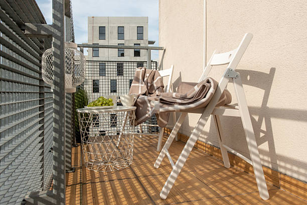 istock Modern Balcony Lounge With Chairs, Table, and Relaxing Niches in Urban Setting 2254017631
