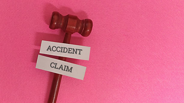 istock Gavel with accident claim labels on pink background 2254018033