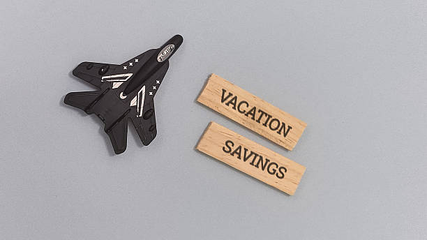 Toy jet with vacation savings plan on wooden blocks